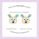 Tiny Jewels cartoon bunny ear studs with text on a light purple background