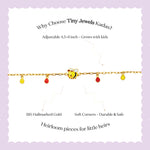 Tiny Jewels bracelet with bee charm on a wrist against a black background 
