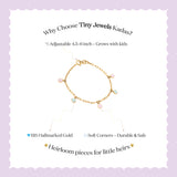 Tiny Jewels gold bracelet with colorful stones on a white background with promotional text about Tiny Jewels Kadas.