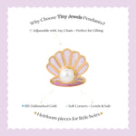 Tiny Jewels shell-shaped pendant with a pearl on a white card with text about Tiny Jewels Pendants.