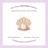 Tiny Jewels shell-shaped pendant with a pearl on a white card with text about Tiny Jewels Pendants.