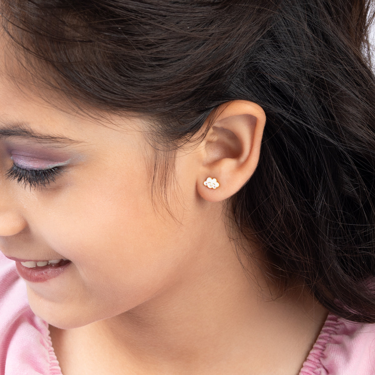 Tiny Jewels close-up of a young girl wearing a small diamond earring.