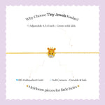 Tiny Jewels gold bracelet with a giraffe design on a white background with text about Tiny Jewels Kadas.