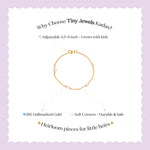 Tiny Jewels gold bracelet on a white background with text about Tiny Jewels Kadas