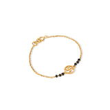 Tiny Jewels gold bracelet with black beads on a white background