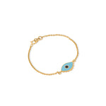 Tiny Jewels gold bracelet with a blue evil eye charm on a white background
