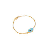 Tiny Jewels gold bracelet with a blue evil eye charm on a white background