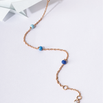 Tiny Jewels necklace with blue beads on a white background