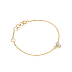 Tiny Jewels gold bracelet with a blue flower charm on a white background