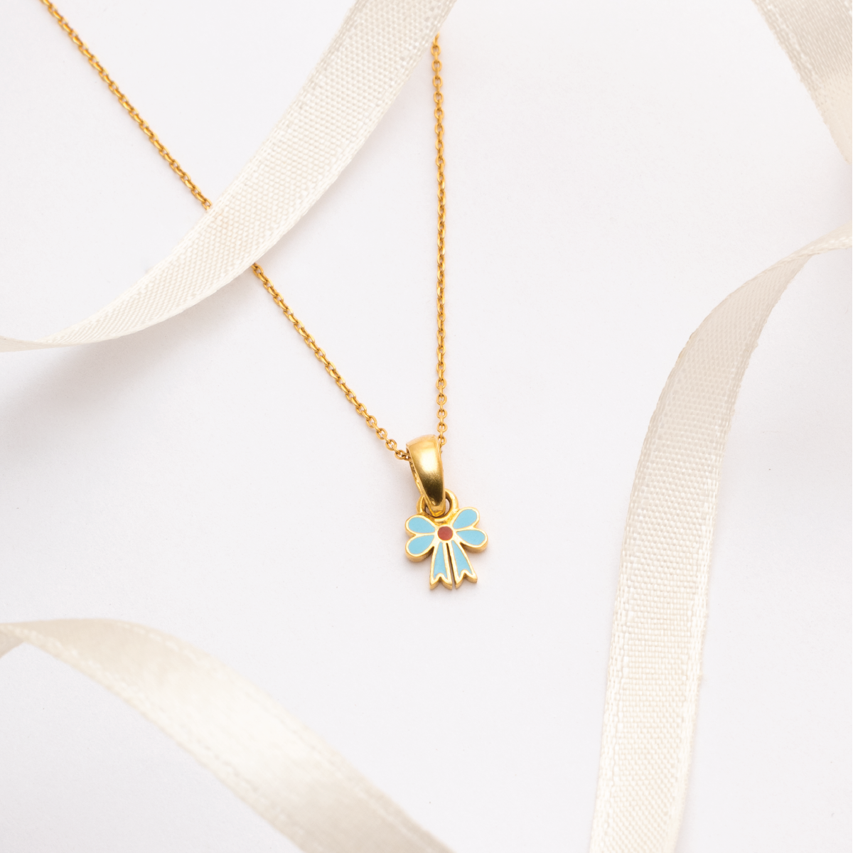 Tiny Jewels gold necklace with a colorful pendant on a white background