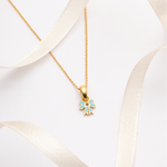 Tiny Jewels gold necklace with a colorful pendant on a white background