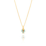 Tiny Jewels gold pendant with a blue flower design on a white background