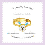 Tiny Jewels gold children's ring with bunny design on a light purple background