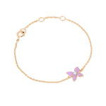 Tiny Jewels gold bracelet with a pink butterfly charm on a white background