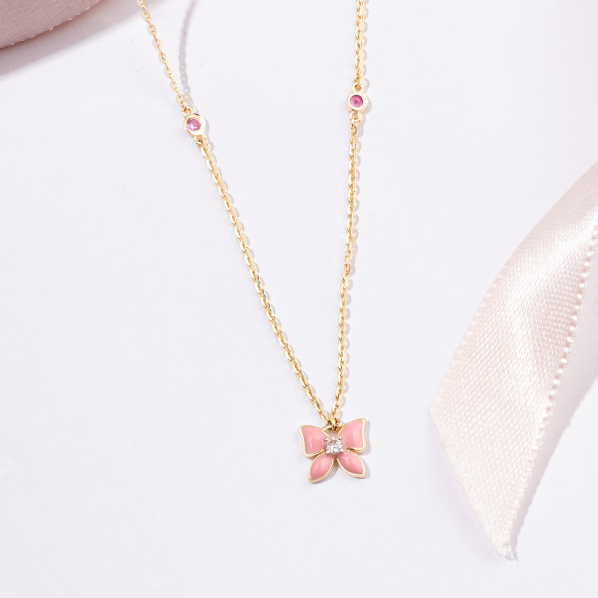 Tiny Jewels pink butterfly pendant necklace on a white background