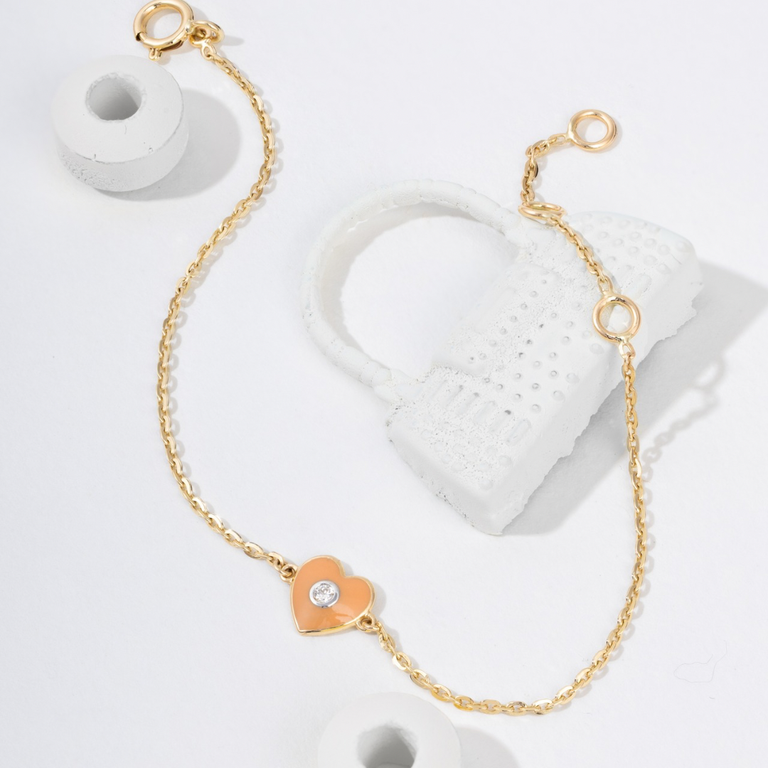 Tiny Jewels gold bracelet with a heart-shaped charm on a white background