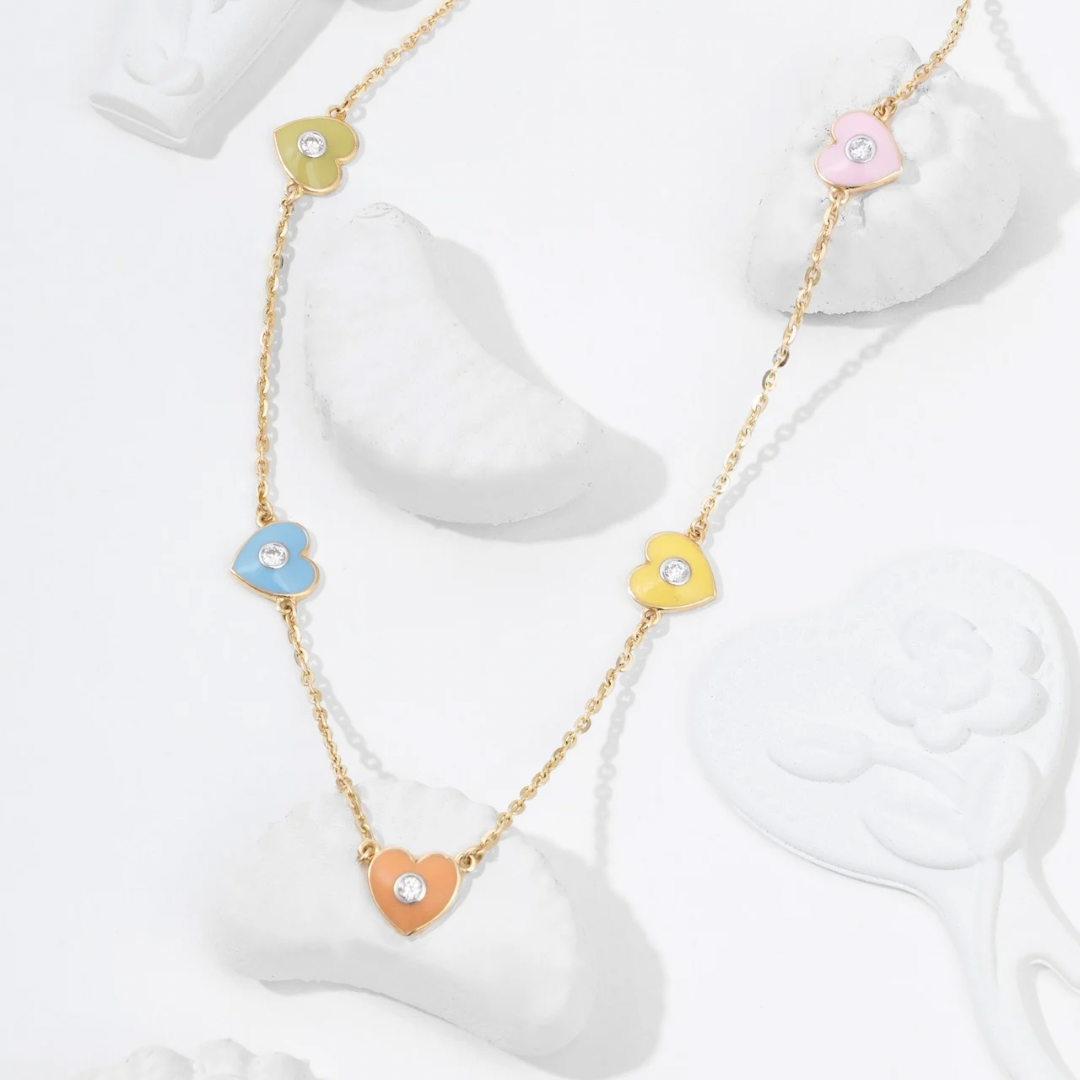 Tiny Jewels necklace with colorful heart-shaped pendants on a white background