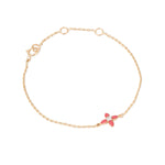 Tiny Jewels gold bracelet with a red flower charm on a white background