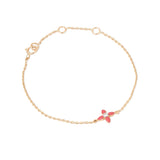 Tiny Jewels gold bracelet with a red flower charm on a white background