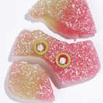 Tiny Jewels gummy candy with gold buttons on a white background