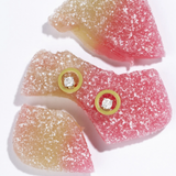 Tiny Jewels gummy candy with gold buttons on a white background
