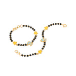 Tiny Jewels black beaded bracelet with gold stars and blue charms on a white background