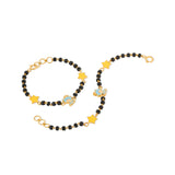 Tiny Jewels black beaded bracelet with gold stars and blue charms on a white background