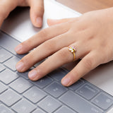 Tiny Jewels hand with a gold ring on a laptop keyboard