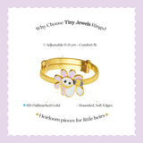 Tiny Jewels gold children's ring with a flower design on a light purple background