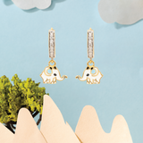 Tiny Jewels gold elephant earrings with diamond accents on a light blue background