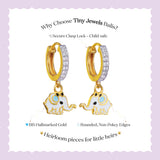 Tiny Jewels gold elephant-shaped earrings with a secure clasp lock on a light purple background.