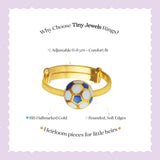 Tiny Jewels gold children's ring with a soccer ball design on a light purple background