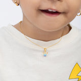 Tiny Jewels child wearing a gold necklace with a colorful pendant on a white background