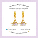 Tiny Jewels gold earrings with heart designs on a purple background, featuring text about 'Tiny Jewels Drops'.