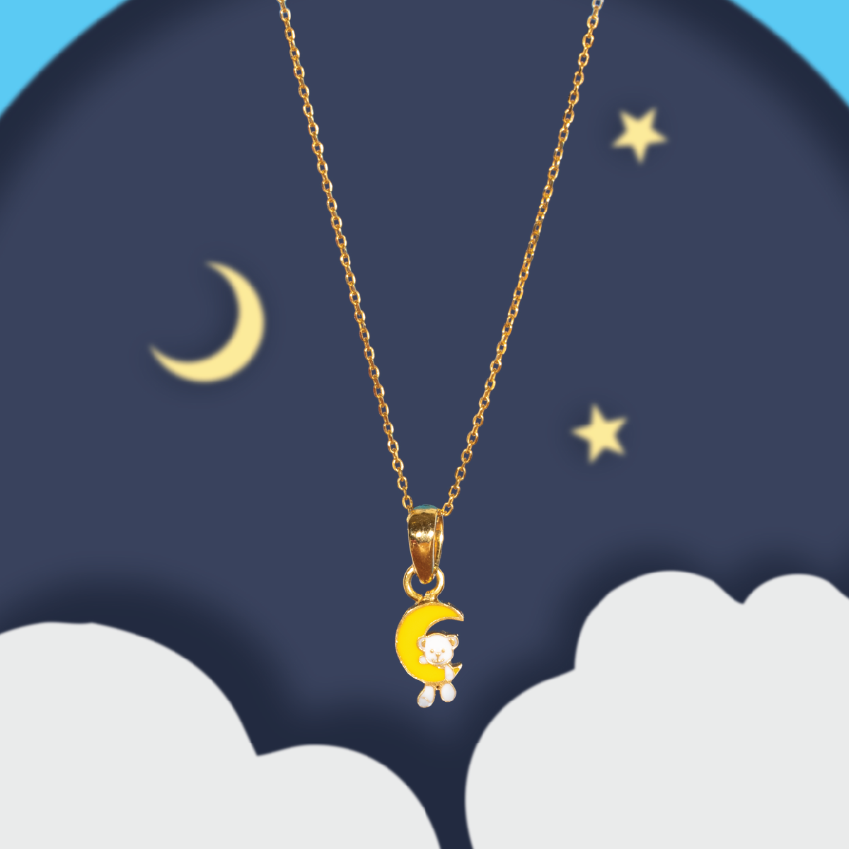 Tiny Jewels Gold necklace with a moon and bear pendant against a night sky with stars and moon.