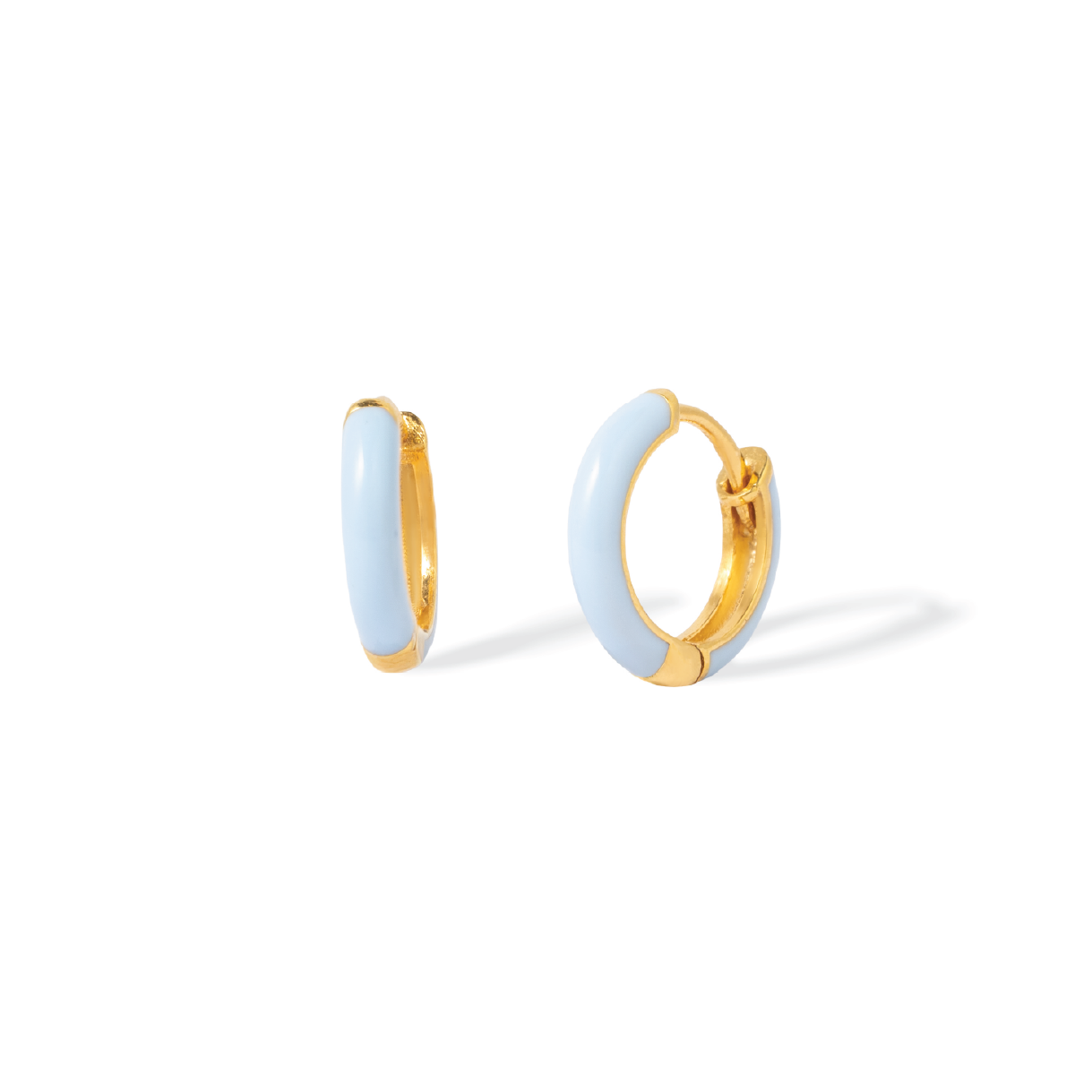 Tiny Jewels gold hoop earrings with light blue circular stones on a white background