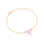 Tiny Jewels gold bracelet with a pink bow charm on a white background