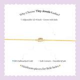 Tiny Jewels gold bracelet with text on a white background