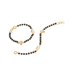 Tiny Jewels black beaded bracelet with gold accents on a white background