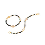 Tiny Jewels black beaded bracelet with gold accents on a white background