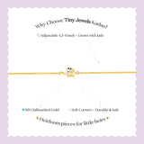 Tiny Jewels gold bracelet with a small owl charm on a child's wrist against a white background
