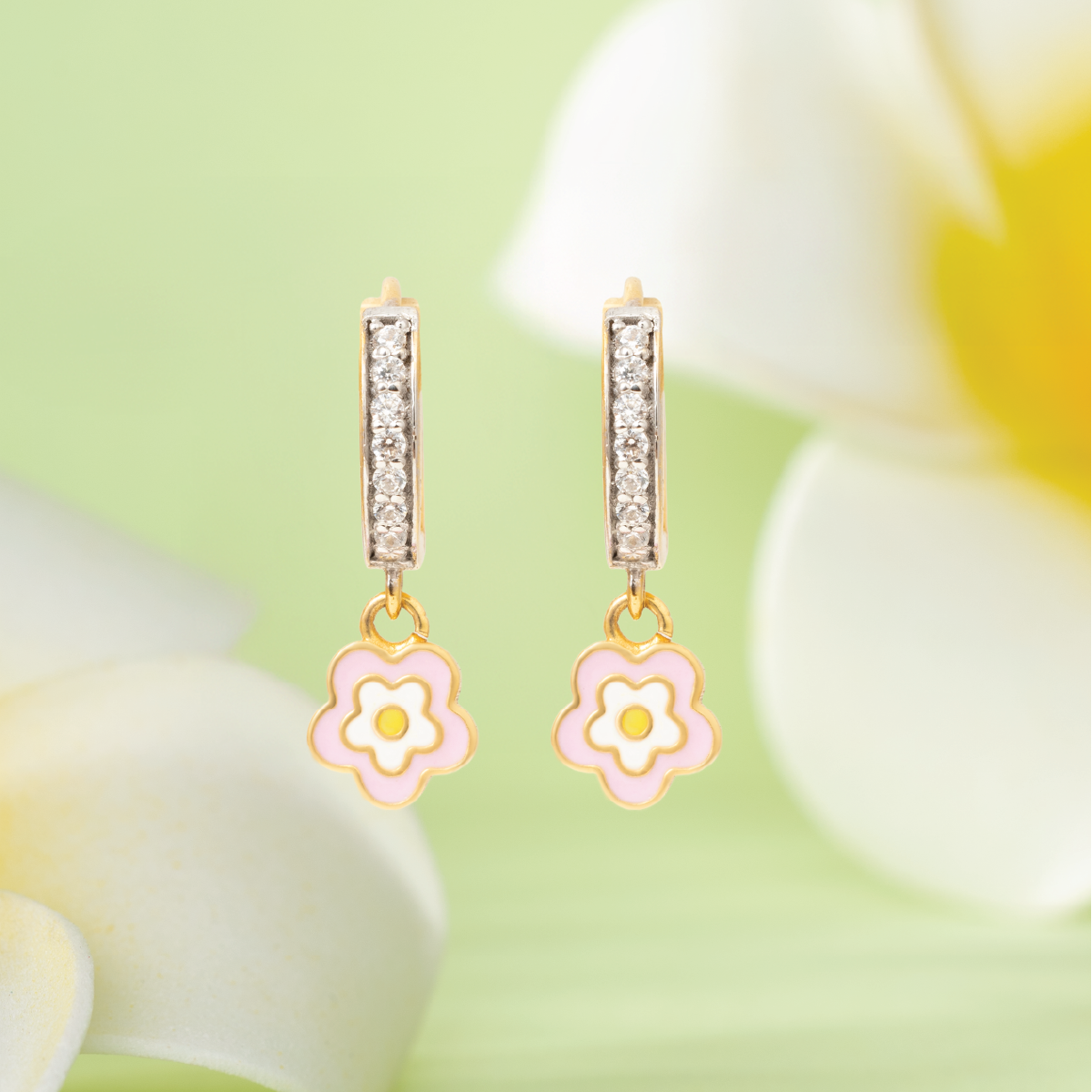 Tiny Jewels flower-shaped earrings with pink flowers on a floral background