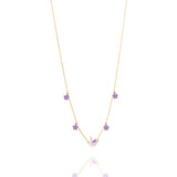 Tiny Jewels gold necklace with purple gemstones on a white background