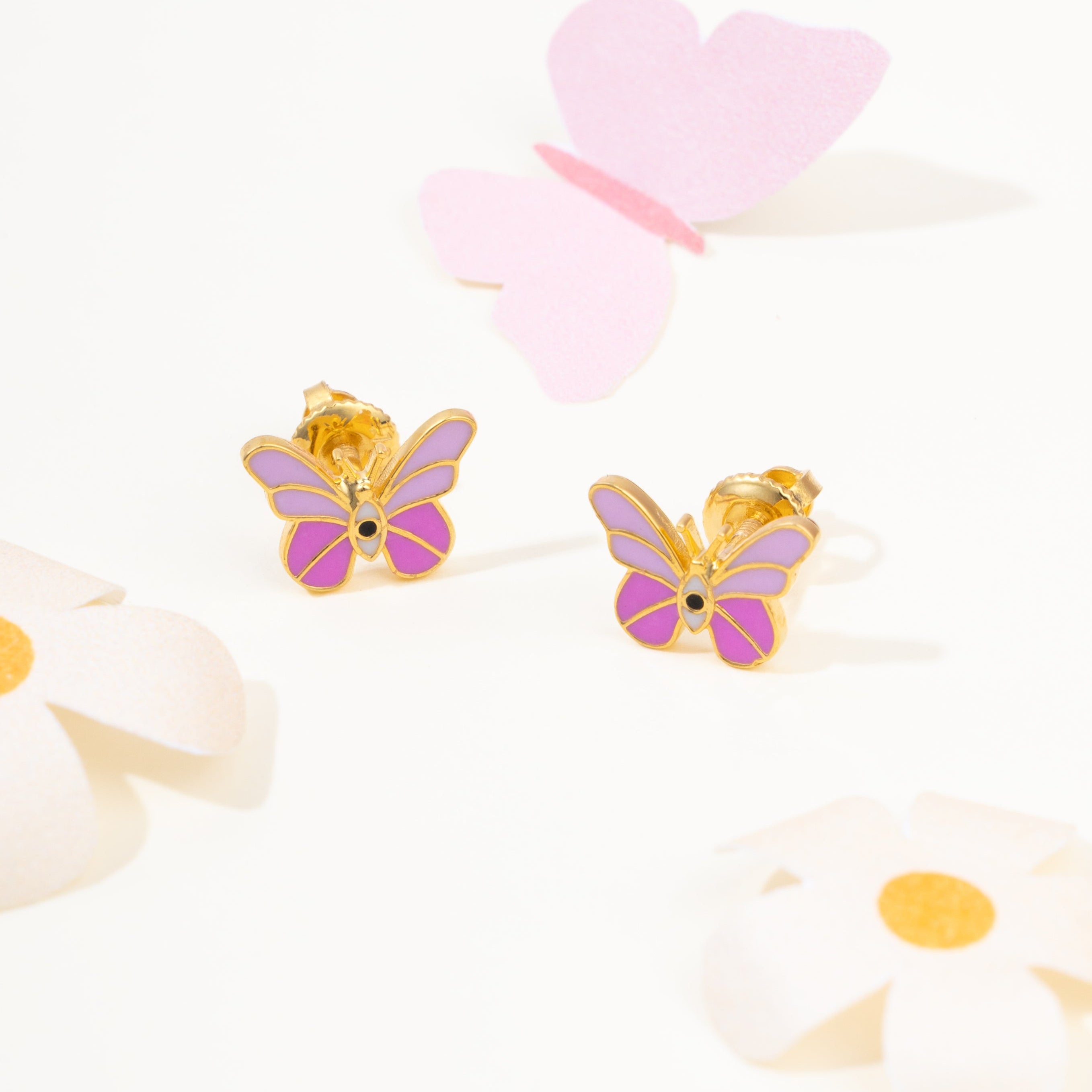 Tiny Jewels butterfly-shaped earrings with gold and purple colors on a white background with flowers and hearts.
