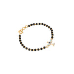 Tiny Jewels bracelet with black beads and gold accents on a white background