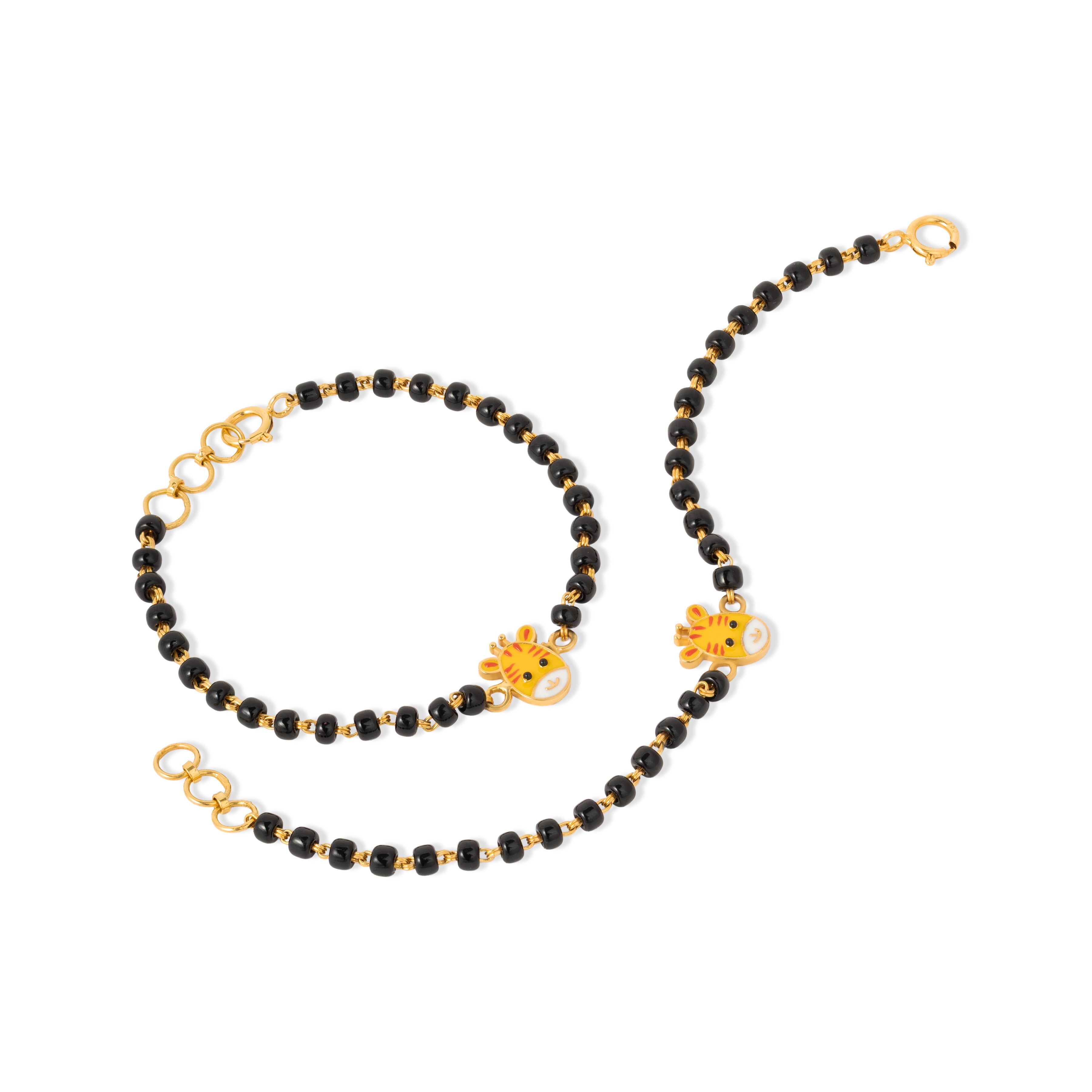Tiny Jewels black beaded necklace with gold chain and charms on a white background