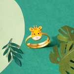 Tiny Jewels gold ring with tiger face design on a green background with leaves