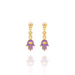 Tiny Jewels gold and purple hamsa hand earrings on a white background