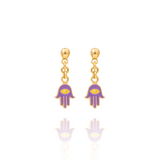 Tiny Jewels gold and purple hamsa hand earrings on a white background