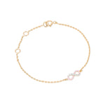Tiny Jewels gold bracelet with a pink and silver infinity charm on a white background